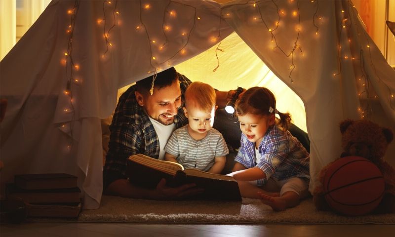 father reading poetry to boys